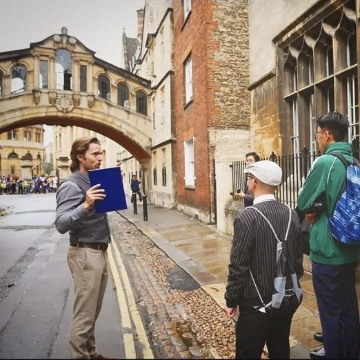 A Berndt Education educator with students at Oxford, the Bridge of Sighs behind